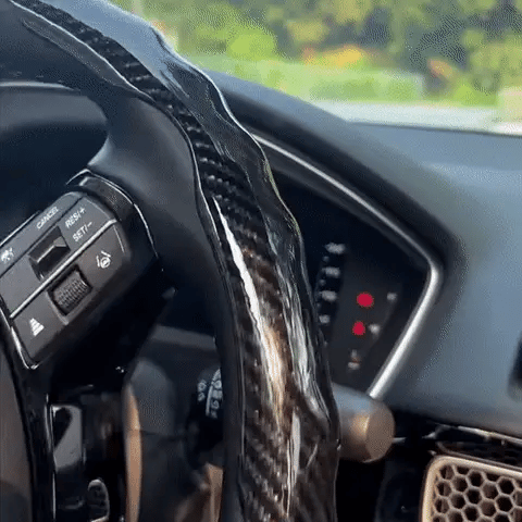 Universal carbon fiber steering wheel cover with non-slip grip, ergonomic design, and sweat-absorbent surface. Temperature-neutral for all-weather comfort, easy card-lock installation, and durable wear-resistant construction.