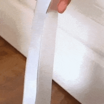 Transparent 5-meter self-adhesive silicone door seal strip, 25mm wide, applied to a door bottom to block cold air, wind, and insects—flexible, durable, and energy-efficient weatherproofing solution.