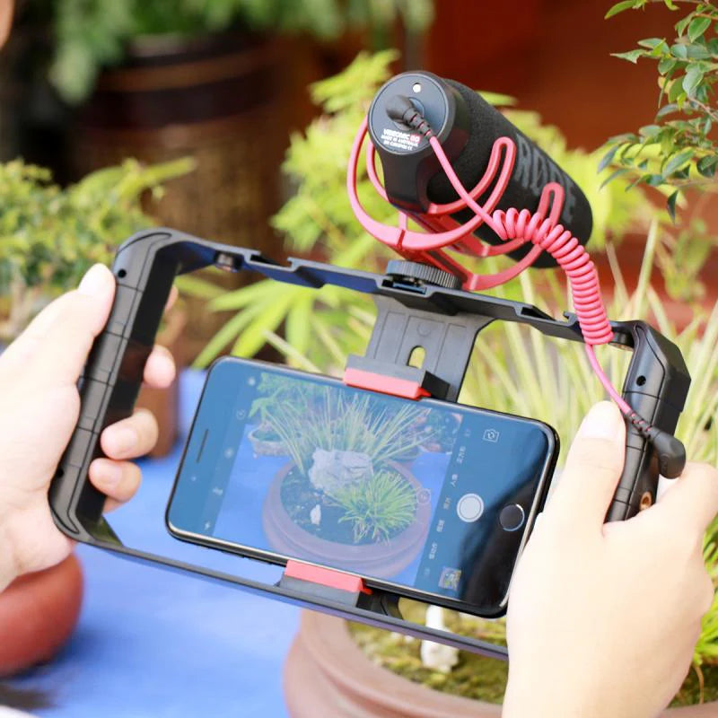 Smartphone video rig stabilizer with ergonomic grip, built-in LED light, and cold shoe mounts for pro-quality filming on iPhone or Android.