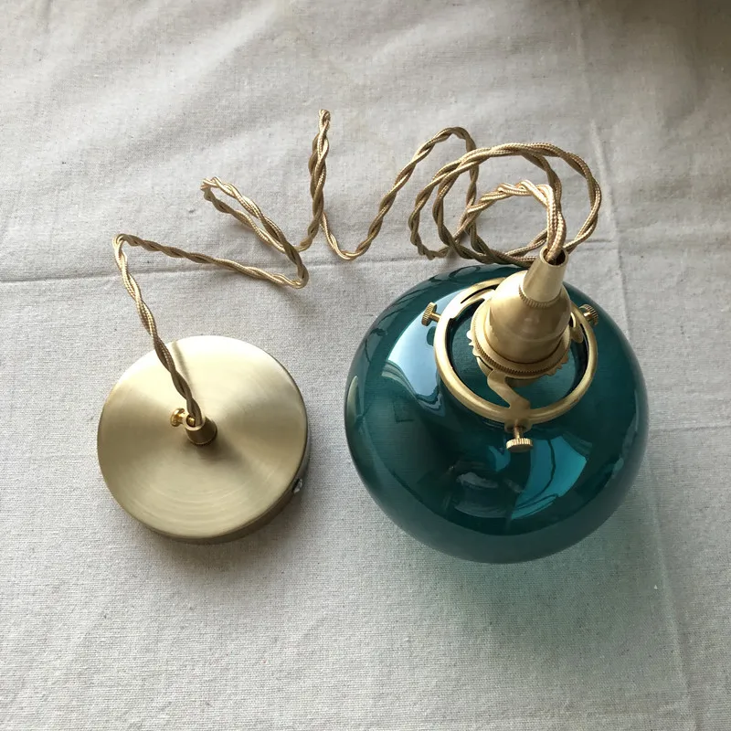 Lumora Hand-Blown Teal Glass Orb Pendant Light with Brushed Brass