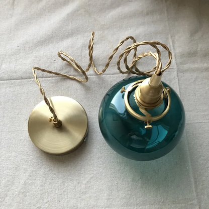 Lumora Hand-Blown Teal Glass Orb Pendant Light with Brushed Brass