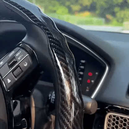 Universal carbon fiber steering wheel cover with non-slip grip, ergonomic design, and sweat-absorbent surface. Temperature-neutral for all-weather comfort, easy card-lock installation, and durable wear-resistant construction.