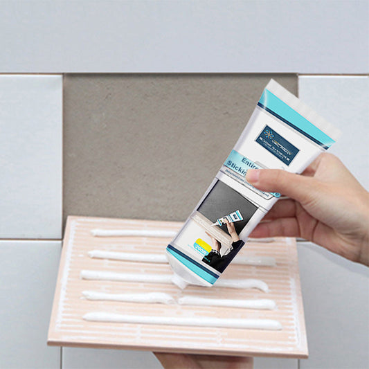 High-performance tile adhesive with a flexible metal nozzle being applied to loose or hollow ceramic tiles for repair and bonding