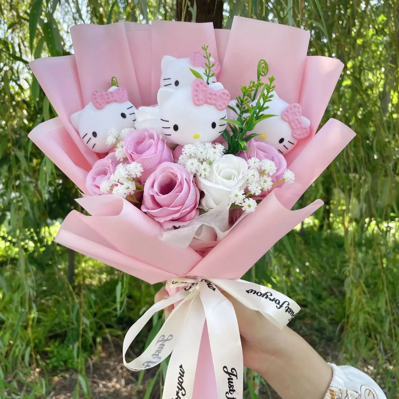 Hello Kitty flower bouquet with vinyl dolls, artificial flowers, wrapped in pink paper, perfect for gifts and special occasions.