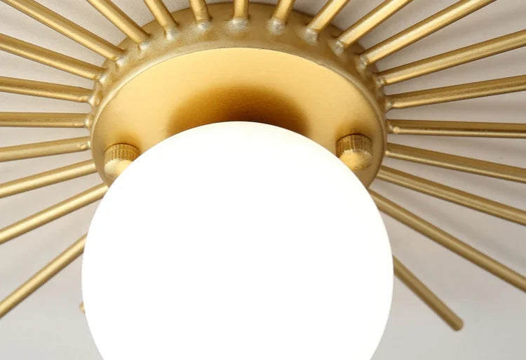 RoyaleGlow Mid-Century Gold Sunburst Flush Mount Ceiling Light with Glass Globe