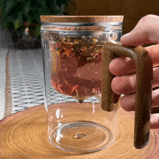Elegant glass teapot with built-in infuser, crafted from durable borosilicate glass. Features anti-scald wooden handle, drip-free spout, and innovative water separation technology for perfect tea brewing. Easy to clean and ideal for loose leaf tea.